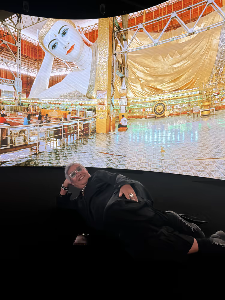 Visitor inside the 360 display during a reclining Buddha panorama.