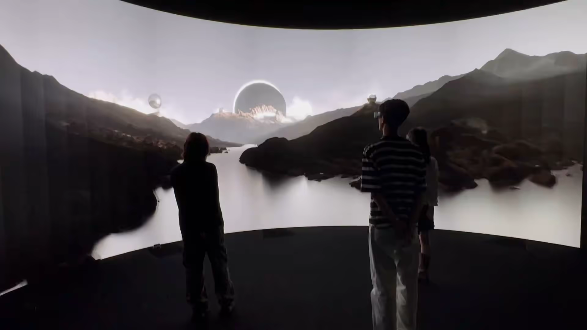 Viewers watching misty mountain and lake scene with floating sphere — VRC