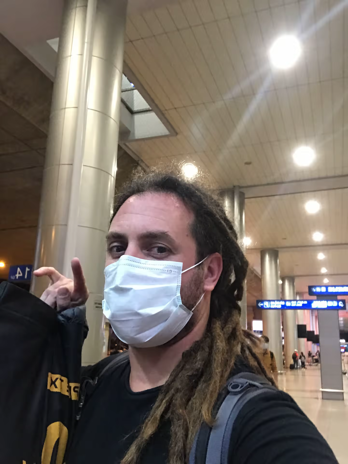 Travel self-portrait wearing a mask