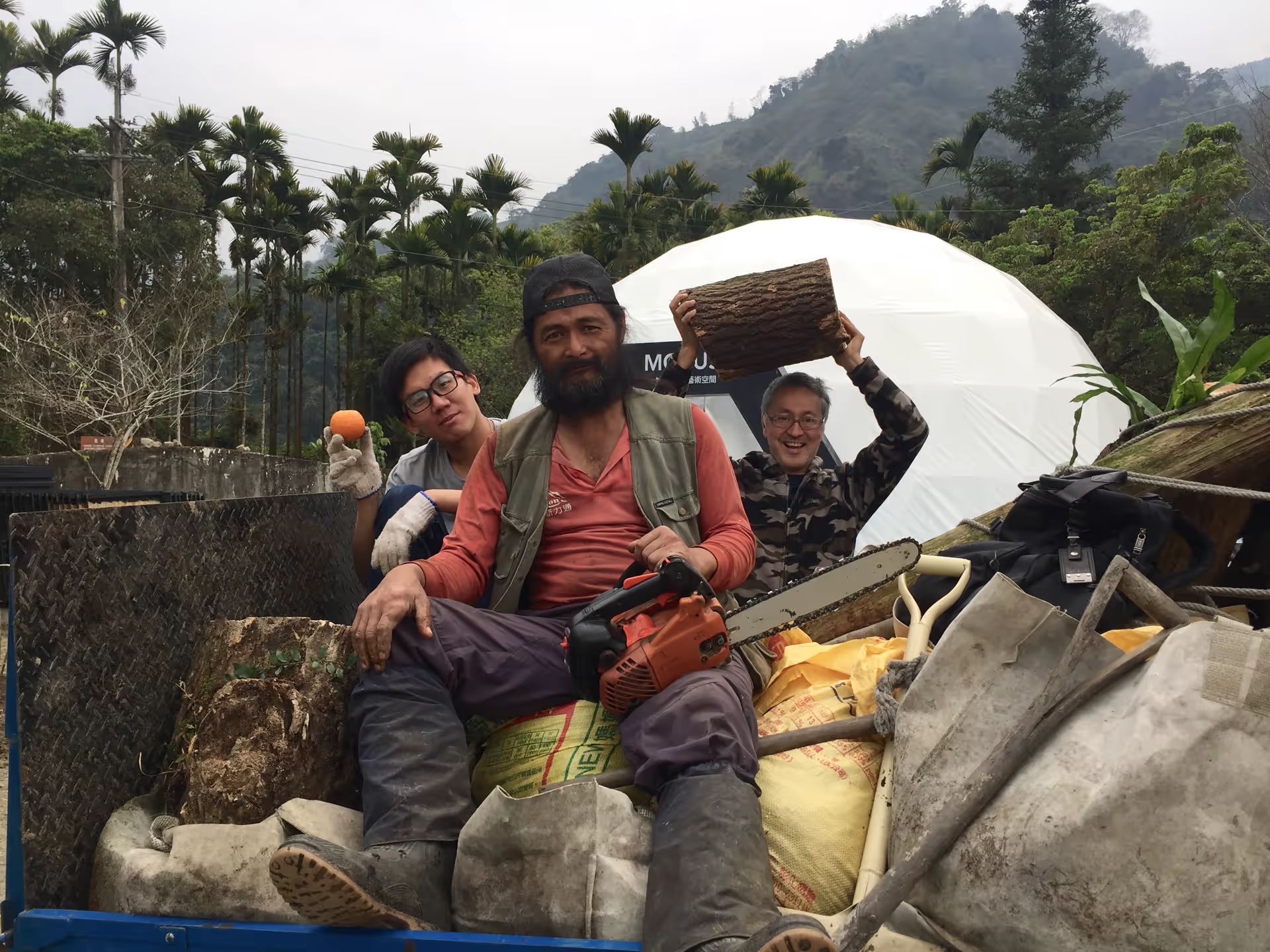 Festival crew on a truck with chainsaw and equipment