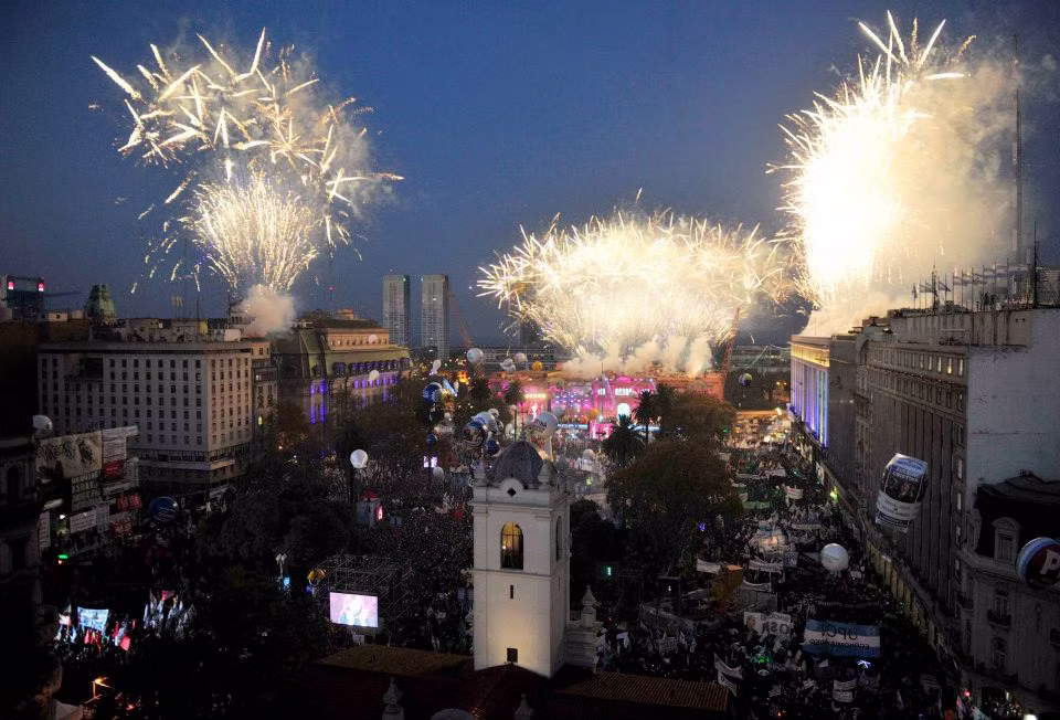 Fireworks over a crowded Plaza de Mayo