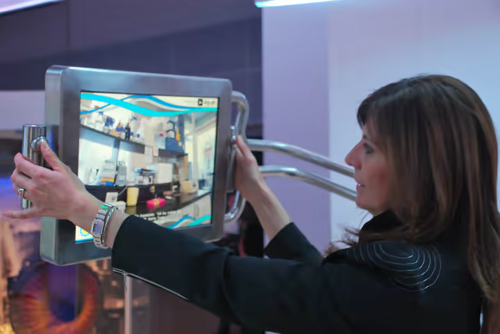 A visitor holding the V-Dome screen while navigating immersive content