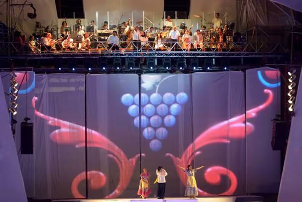 Front detail of dance, live musicians and ornamental projection with grape-cluster motif.